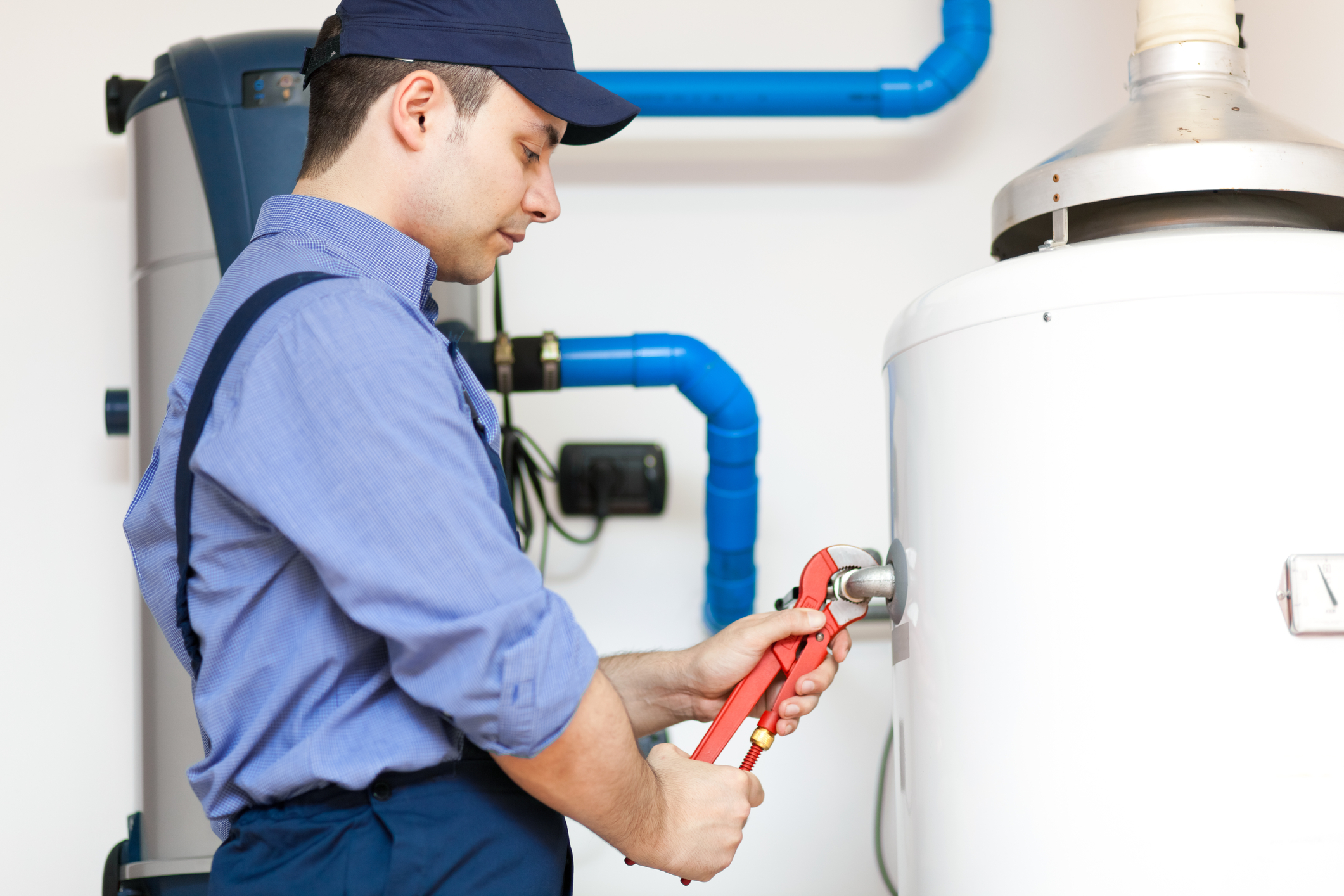 Plumber while repairing an hot-water heater